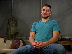 Handsome man tied up to a chair while his gay friend blows him