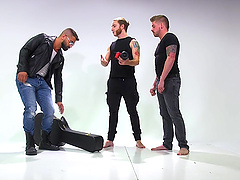 Tied up guy with a ball gag tortured and pleasured by his gay friends