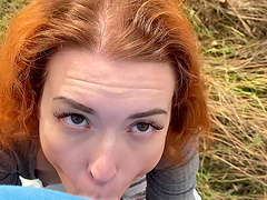 Closeup outdoors POV video of a cute redhead giving head and riding
