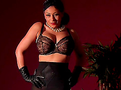 Seductive mature Danica Collins in black lingerie plays with her puss