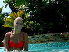 Rikki takes a swim in a pool before playing with her hot pussy