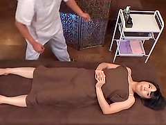 Oiled Japanese chick gets her pussy fingered and gives a blowjob