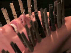 Pain loving girl gets her body pinched by clothespins