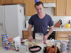 Good looking dude enjoys while cooking dinner in the kitchen