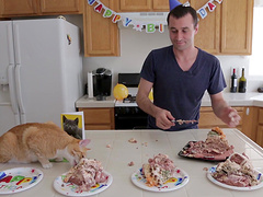 Good looking dude enjoys while cooking dinner in the kitchen