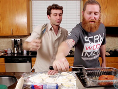 Video of two handsome guys preparing the lunch in a kitchen