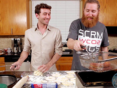 Video of two handsome guys preparing the lunch in a kitchen