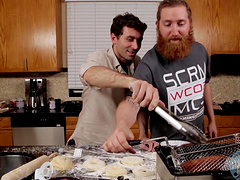Video of two handsome guys preparing the lunch in a kitchen