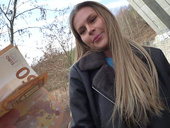 Guy and girl have fun in his car.