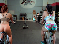 Fitness enthusiasts Kira Perez and Nadia White flex muscles for Peter Green.