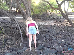 Natural blonde Melody Marks strips down to pose nude on the beach