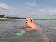 Mature blonde Beth enjoys solo play on the beach