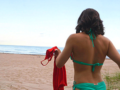 Solo girl shows off her natural tits at the beach