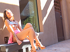 Skinny brunette in miniskirt flashes her tits in public