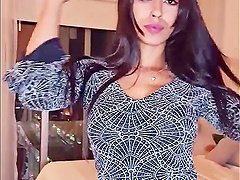 Brunette webcam goddess shows off her long hair while stripping down