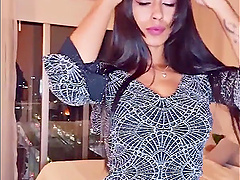 Brunette webcam goddess shows off her long hair while stripping down