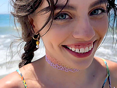 Petite Angel Windell shows off her shaved pussy on the beach