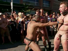 There is a whole crowd and Drew is being poked by a lot of men