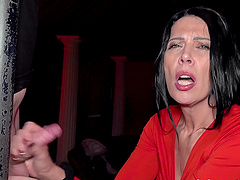 Beautiful brunette milf gets a good oral sex from two men at the club.