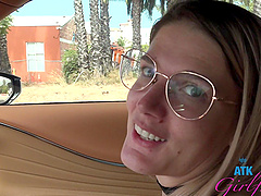 Beautiful woman with glasses Riley Rose has natural big boobs and wears a tattoo.