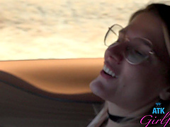 Beautiful woman with glasses Riley Rose has natural big boobs and wears a tattoo.