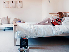 Ella Hughes is a sexy redhead who wears lingerie and uses sex toys.