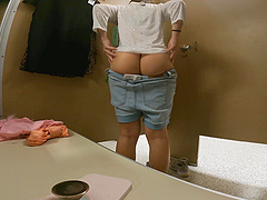 Beautiful long-haired woman in a thong shows off her big ass.