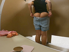 Beautiful long-haired woman in a thong shows off her big ass.