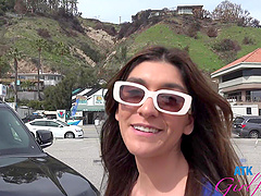 Beautiful woman with glasses gives a great blowjob in a public place.