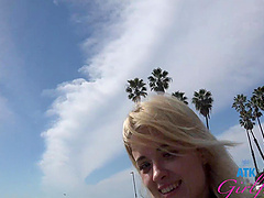 A blonde beauty with long hair gives a blowjob while sitting in a car.