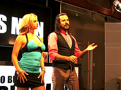 Beautiful women with amazing assets pose in the middle of the set.