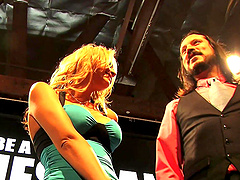 Beautiful women with amazing assets pose in the middle of the set.