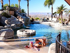 A hot brunette with big natural boobs has fun by the pool with her boyfriend.