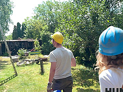 A couple has outdoor fun with a blonde in nature wearing shorts