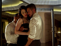 Two guys share a hot brunette's pussy in an intense threesome scene.