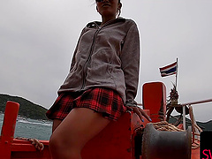 Thai babe in a mini skirt teases with a stealthy POV handie outside