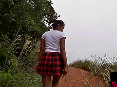 Thai babe in a mini skirt teases with a stealthy POV handie outside