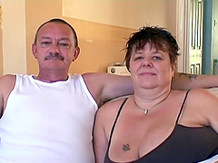 Mature fattie titfucks a cock and gets fucked doggy style