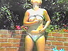 Cougar in panties masturbating affectionately rubbing her pussy outdoors