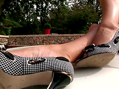 Zuzana Z, in high heels, fingers her pussy in outdoor foot fetish clip