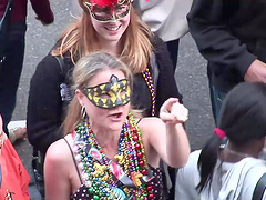 Amateur slut flashes her tits during a carnival in the street