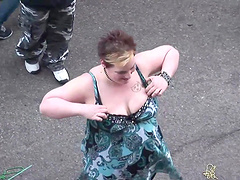 Amateur slut flashes her tits during a carnival in the street