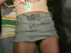 Horny party girl in a revealing miniskirt fondling her tits