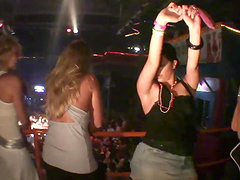 Horny party girl in a revealing miniskirt fondling her tits