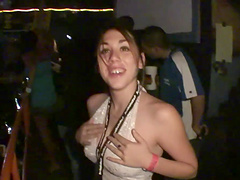 Horny party girl in a revealing miniskirt fondling her tits