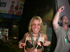 Horny party girl in a revealing miniskirt fondling her tits