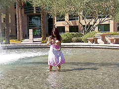 Entrancing brunette with natural tits fingering her shaved pussy outdoors